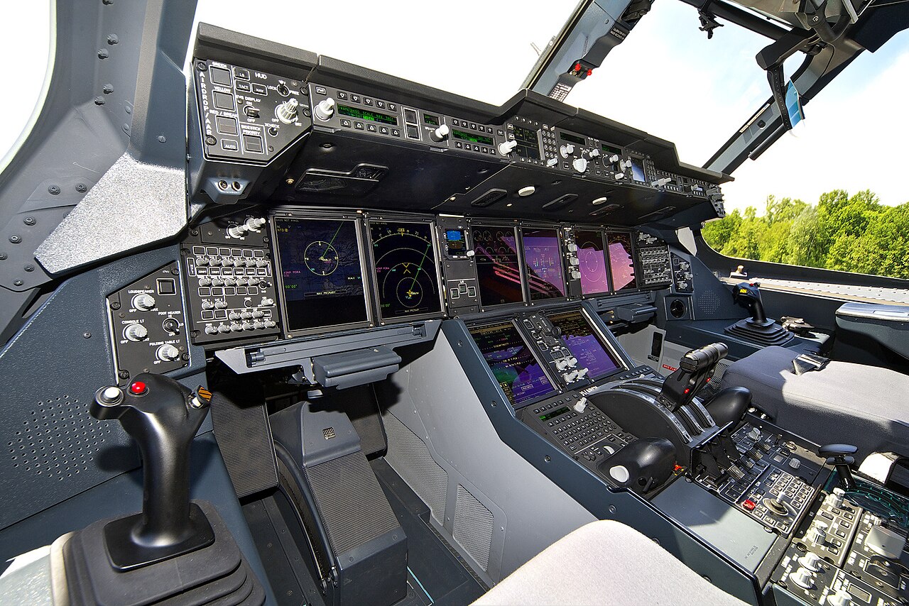 The glass cockpit of an Airbus A400M, with multiple multifunction displays and fly-by-wire sidesticks